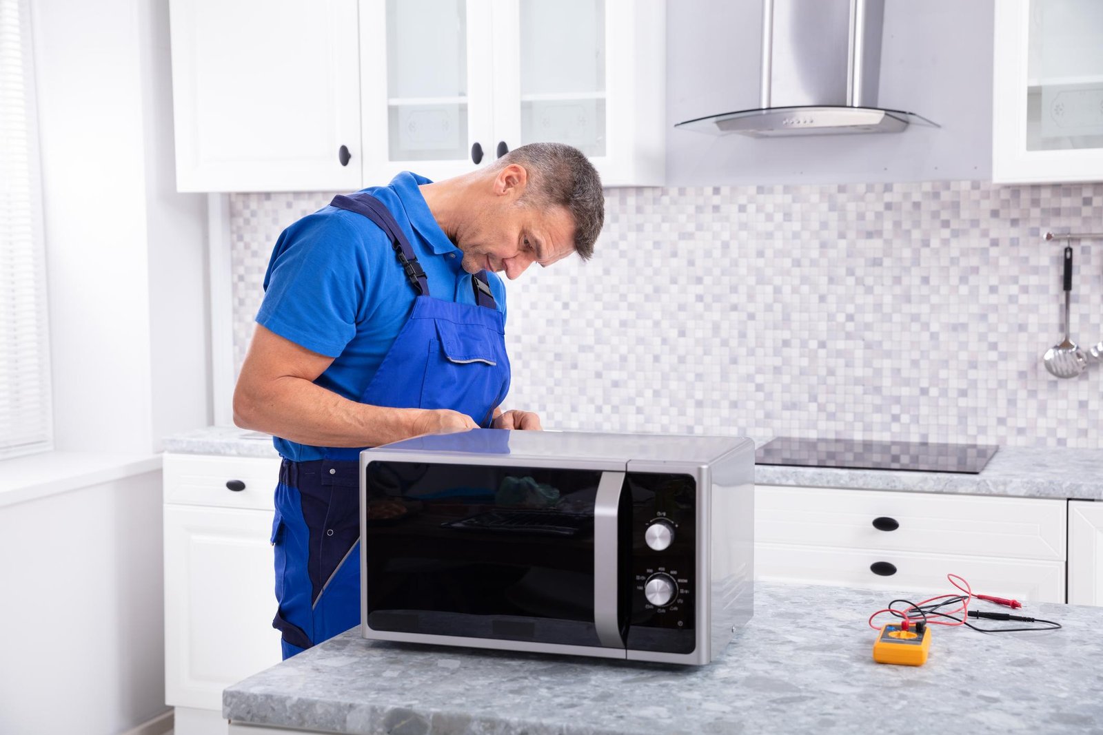 Technician repairing a microwave oven