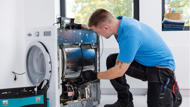 Technician repairing a washing machine